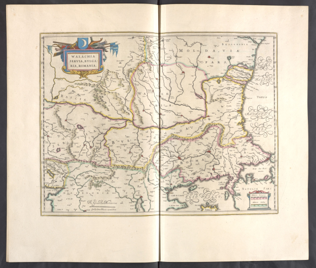 Open book displaying a detailed map of Poland and Hungary against a black background, showing their borders.