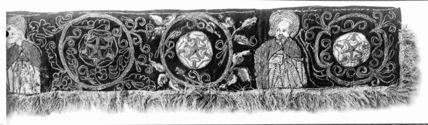 Black and white textile with intricate geometric patterns and bold text in a decorative design.