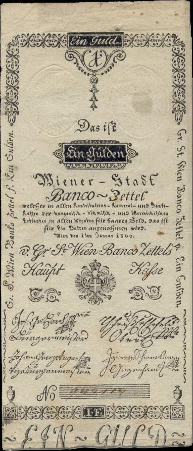 Old German banknote with a black background featuring a man's face and text reading "St. Wien - Stäse Banco-Settel".