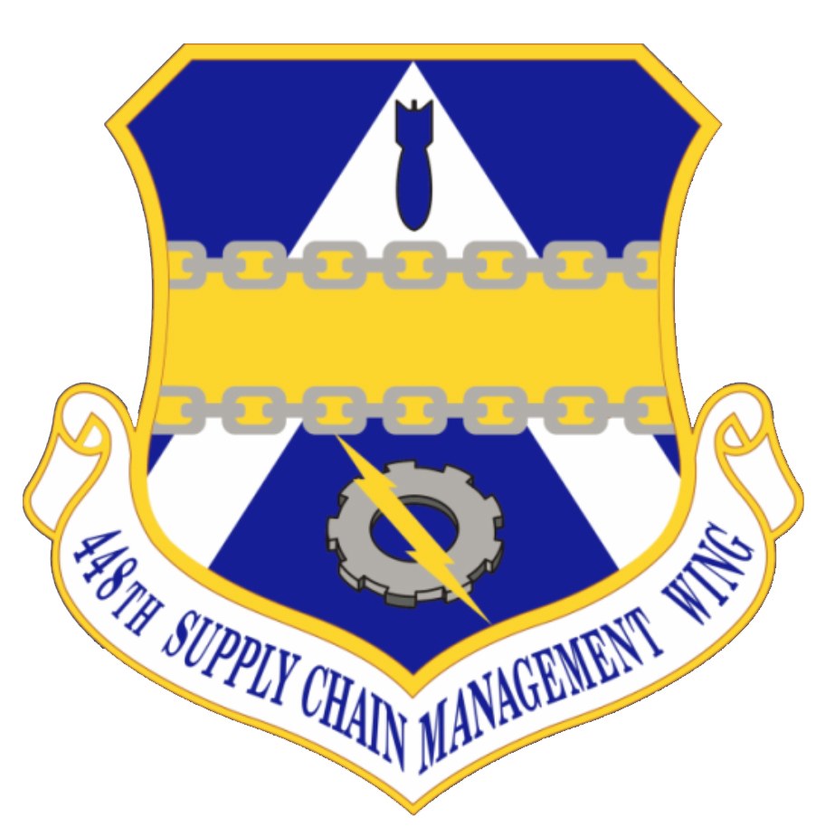 Logo des 48. Versorgungsgeschwader mit einem blauen Schild, einem weißen Stern und einem weißen Banner mit der Aufschrift "Versorgungsgeschwader" in blau, alles von einem weißen Rand und schwarzer Schrift umrandet.