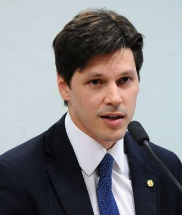 A man in a suit and tie speaks into a microphone at a podium, likely addressing the government's approval of a bill to ban internet use.