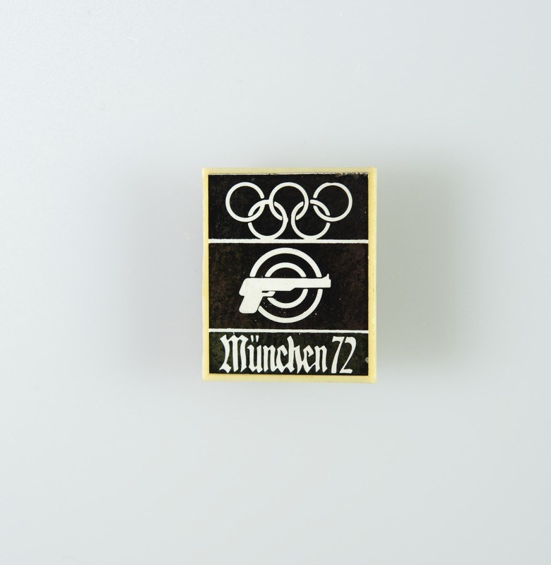 Black and white logo for München 1972 featuring a stylized figure with outstretched arms inside a circle and bold black text.