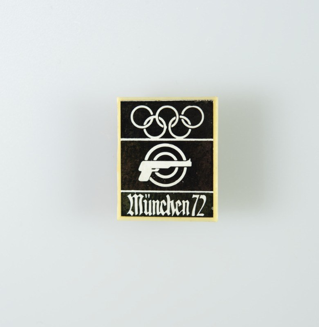 Black and white logo for München 1972 featuring a stylized figure with outstretched arms inside a circle and bold black text.