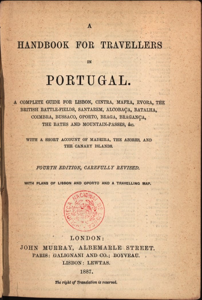 A handbook for travelers in Portugal with a stamp on the cover, open to a page featuring a detailed map of Portugal in traditional Portuguese font.
