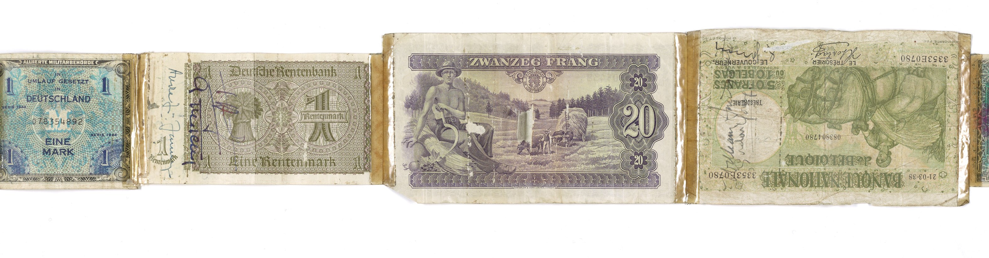 An old book with a pile of various-denomination German banknotes on top.