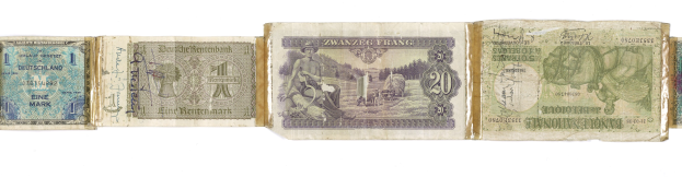 An old book with a pile of various-denomination German banknotes on top.